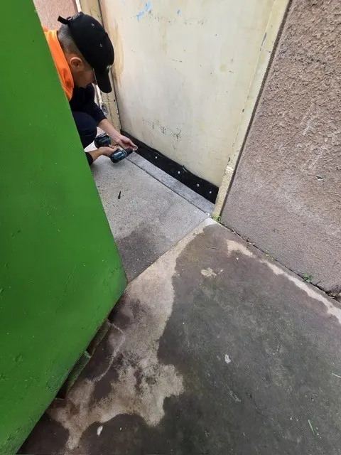Rodent-Proof Door Strip Being Installed